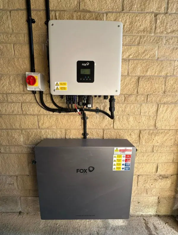 Fox ESS inverter and battery on a stone wall