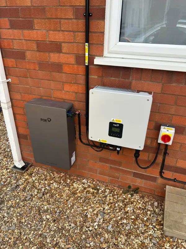 Fox ESS battery and inverter on a brick wall