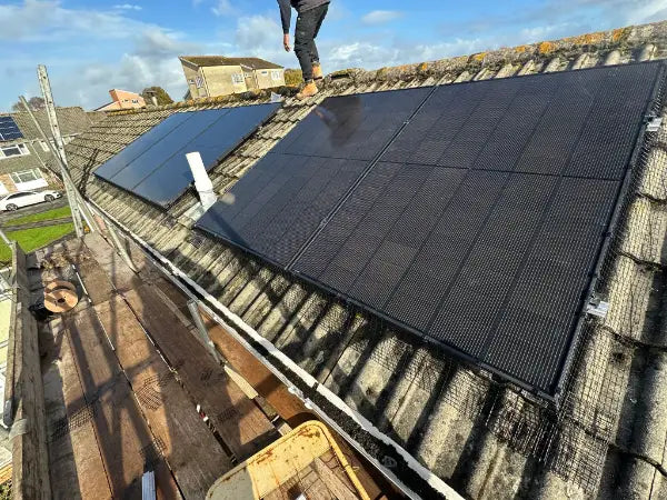 Panels going on, with the fitter on the roof