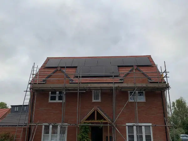 Solar panels on a new-build roof, scaffold still up