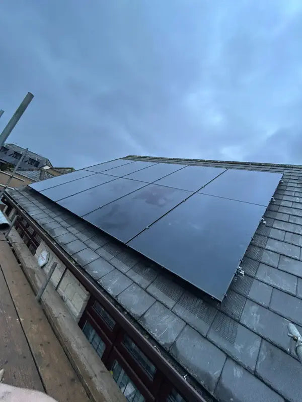Panels on a slate roof under a grey sky