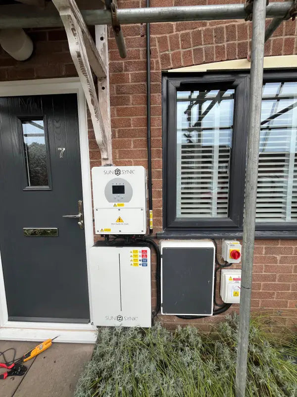 Inverter and battery fitted neatly beside a front door