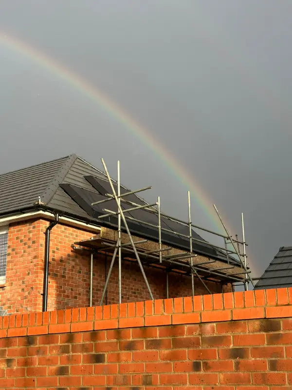Scaffold up for a roof install, under a rainbow